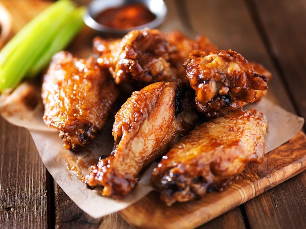 A closeup of a plate of chicken wings.
