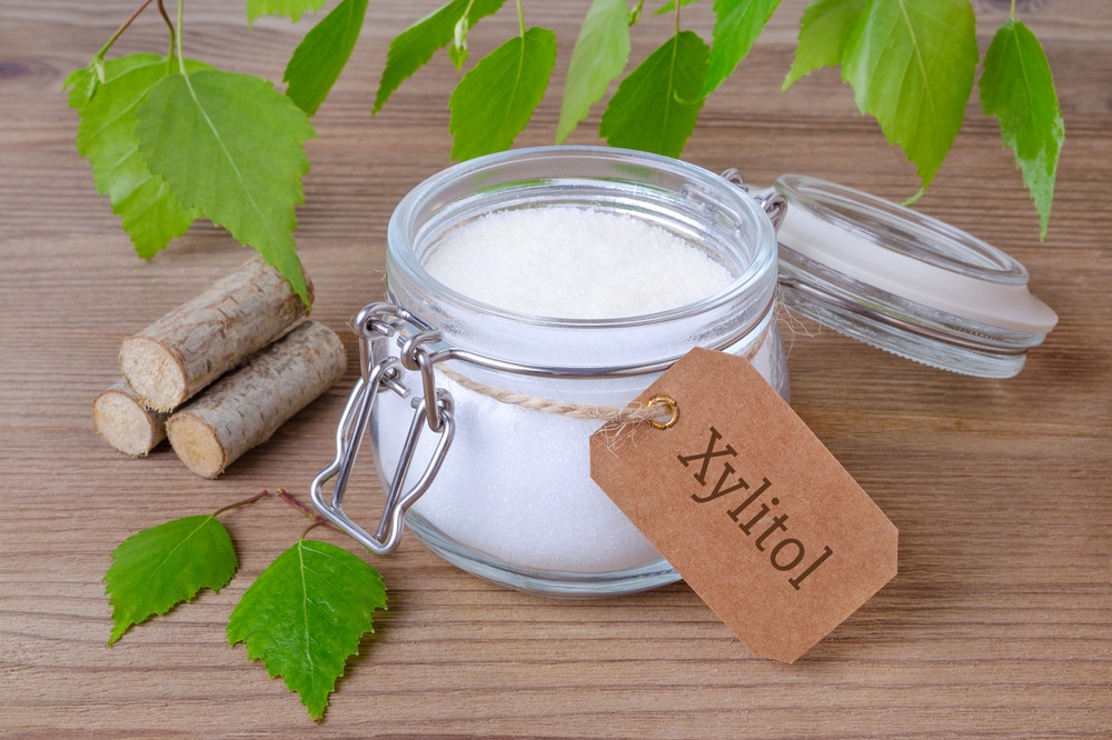 A jar of xylitol with a label next to some more.