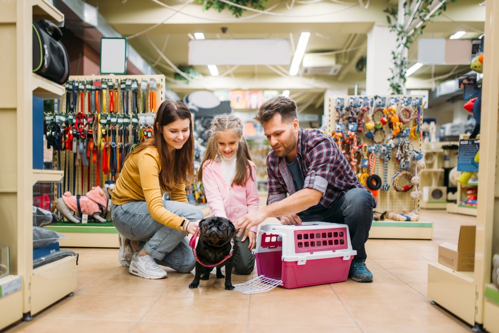 A family with a dog in a pet store.